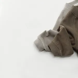 Detail showing knit texture and ribbed cuffs of retro style children tops in two colors