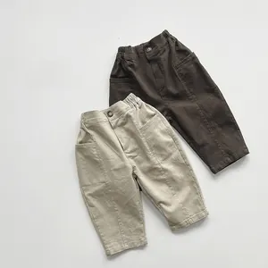 Detail view of elastic waist and pocket stitching on kids casual cotton trousers