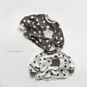 Detail of polka dot cotton sweatshirts with contrast chest pockets and ribbed cuffs