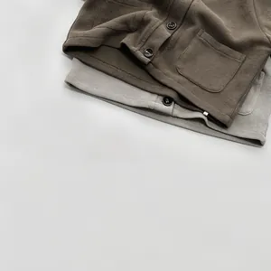Close-up of ribbed knit cardigans with buttons and front pockets in olive and grey