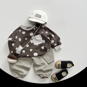 Toddler kids autumn outfit featuring a brown polka dot long sleeve shirt and green pants