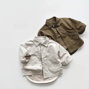 Close-up of children's retro collared shirts with large pockets in beige and olive green