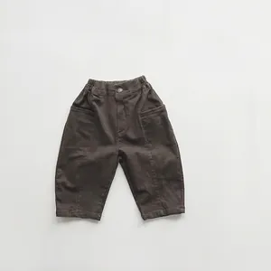 Detail of children's cotton trousers featuring elastic waistband and large side pockets