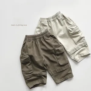 Close-up of kids cargo shorts with elastic waist and large flap pockets in khaki and beige