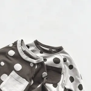 Detailed view of kids' polka dot long sleeve T-shirts with raglan sleeves and chest pockets