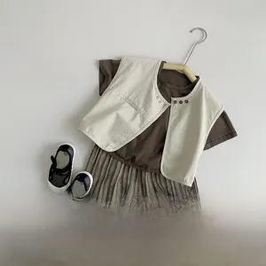Flat lay of vintage style kids vest set with brown T-shirt and striped pants