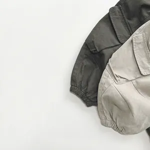 Kids cargo pants in olive green and beige colors with large side flap pockets and elastic cuffs
