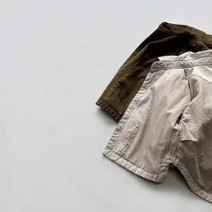 Korean style kids cotton linen set with olive green shirt and beige shorts in flat lay
