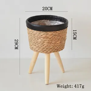 Detail of hand-woven plant stand with wooden legs and clear waterproof inner liner