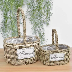 Detail view of woven flower baskets with waterproof liners and Flowers label on wood surface