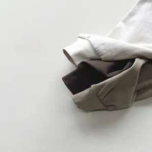 Detail view of cotton long sleeve kids tops showing ribbed cuffs and soft knit texture