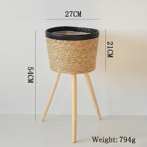 Detail view of woven rattan planter with dimensions 27x54cm and three wooden legs
