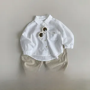 Flat lay of breathable white cotton linen shirt with khaki shorts for toddlers