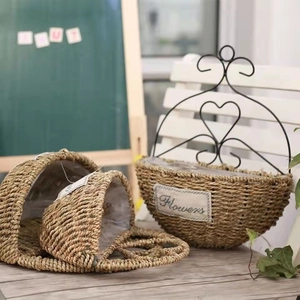 Detail of handmade straw wall basket with heart hook and Flowers label for home decor