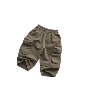 Kids olive green cargo pants with elastic waist and large side pockets on white background
