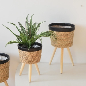 Close-up of woven seagrass plant stands with waterproof liners and wooden legs