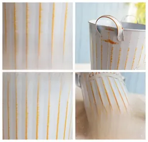 Detail view of vintage white and orange striped metal garden pot with embossed GARDEN text