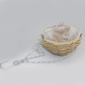 Detail of hand-woven wicker hanging basket with waterproof plastic liner and metal chains