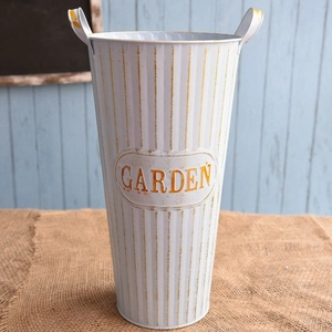 Detailed close-up of a white vintage garden metal bucket with golden ribbed textures