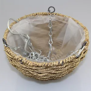 Detail of hanging plant basket showing natural straw weave and waterproof plastic liner