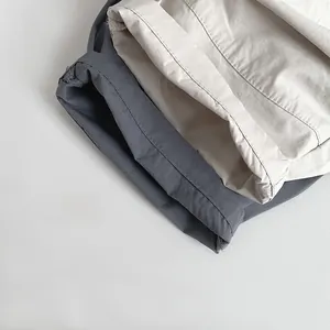 Detailed view of rolled hems and precise stitching on kids' linen cotton trousers