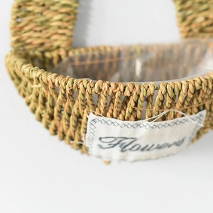Detail of hand-woven grass flower basket featuring a waterproof liner and Flowers patch
