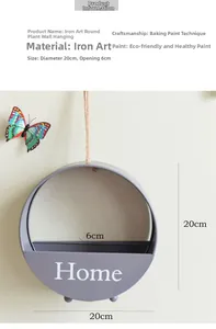 Detail view of round iron wall planter with Home text and matte lavender finish