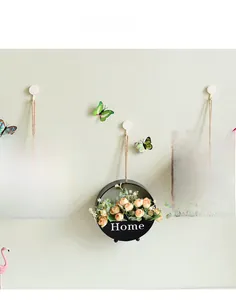 Three-piece set of wall-mounted metal planters with Home lettering and faux roses