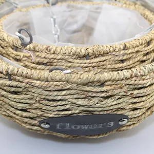 Detail of hanging wicker basket with waterproof plastic lining and metal flower label