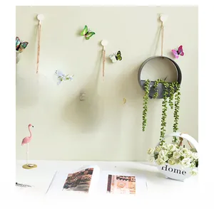 Macro detail of wall-mounted circular plant pots with Home text and hanging ropes