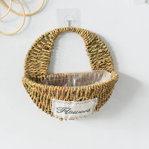 Handwoven straw wall basket with a Flowers label and waterproof liner for plants