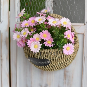 Hanging woven straw flower basket with pink daisies and metal flowers plaque decor