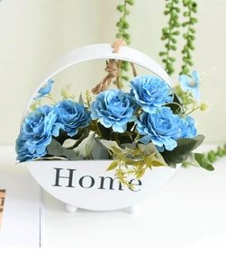 Close-up of Nordic hanging wood basket with blue roses and Home text on white pot