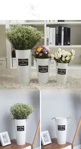 Three-piece white vintage metal flower buckets with rope handles and garden logo