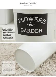 Detailed macro view of white metal flower bucket with vintage Flowers and Garden logo
