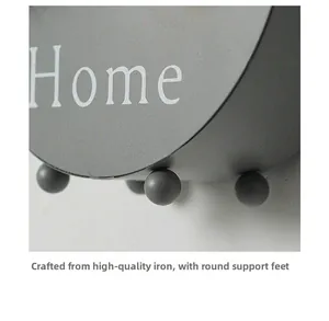 Close-up of iron wall planter featuring durable round support feet and Home lettering