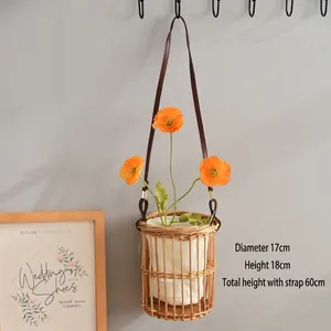 Detail view of woven bamboo basket with 17cm diameter and leather strap for wall hanging