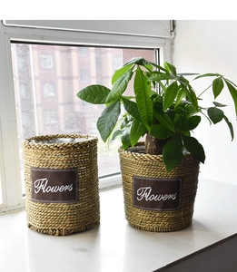 Detail showing handwoven texture and Flowers leather patch on a large straw planter pot