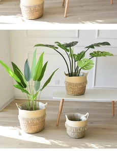 Close-up of woven straw plant pots with tassel details and waterproof plastic liners
