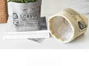 Detail view of fabric planter bag with waterproof lining and printed typography design