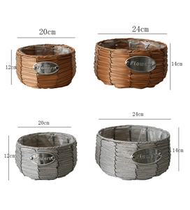 Detail of woven straw flower baskets with waterproof lining and metal flowers tag