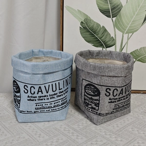 Detail of light blue and dark grey fabric storage bags with thick foldable rims and text