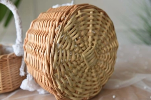 Detailed close-up of handmade woven rattan basket base with lace and pearl accents