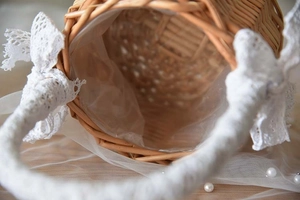 Close-up of handmade wicker flower basket with white lace trim and waterproof lining
