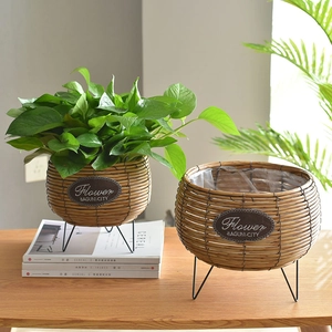 Handwoven rattan round planters with black metal tripod stands and waterproof lining