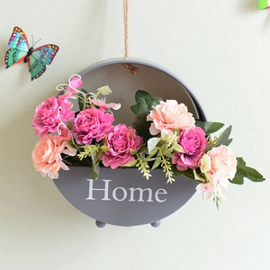 Hanging semi-circle grey metal planter with Home text and pink faux flowers decoration