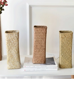 Trio of rectangular woven seagrass vases in natural beige and brown tones for home decor