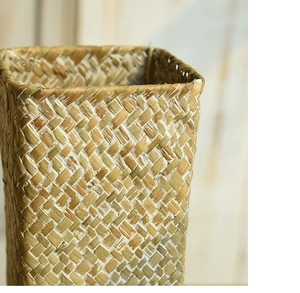 Macro view of detailed hand-woven natural seagrass texture on a decorative flower vase