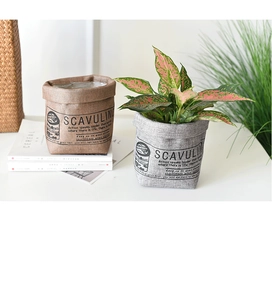 Detailed view of nordic brown and grey fabric plant pot covers with vintage prints