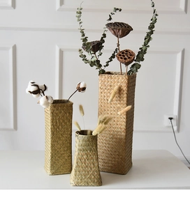 Detailed texture of hand-woven seagrass flower vases with dried floral arrangements